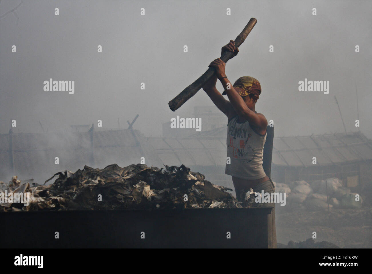 A Bangladeshi day labor works in the polluted environment at Hazaribagh tannery area in Dhaka, Bangladesh. Stock Photo