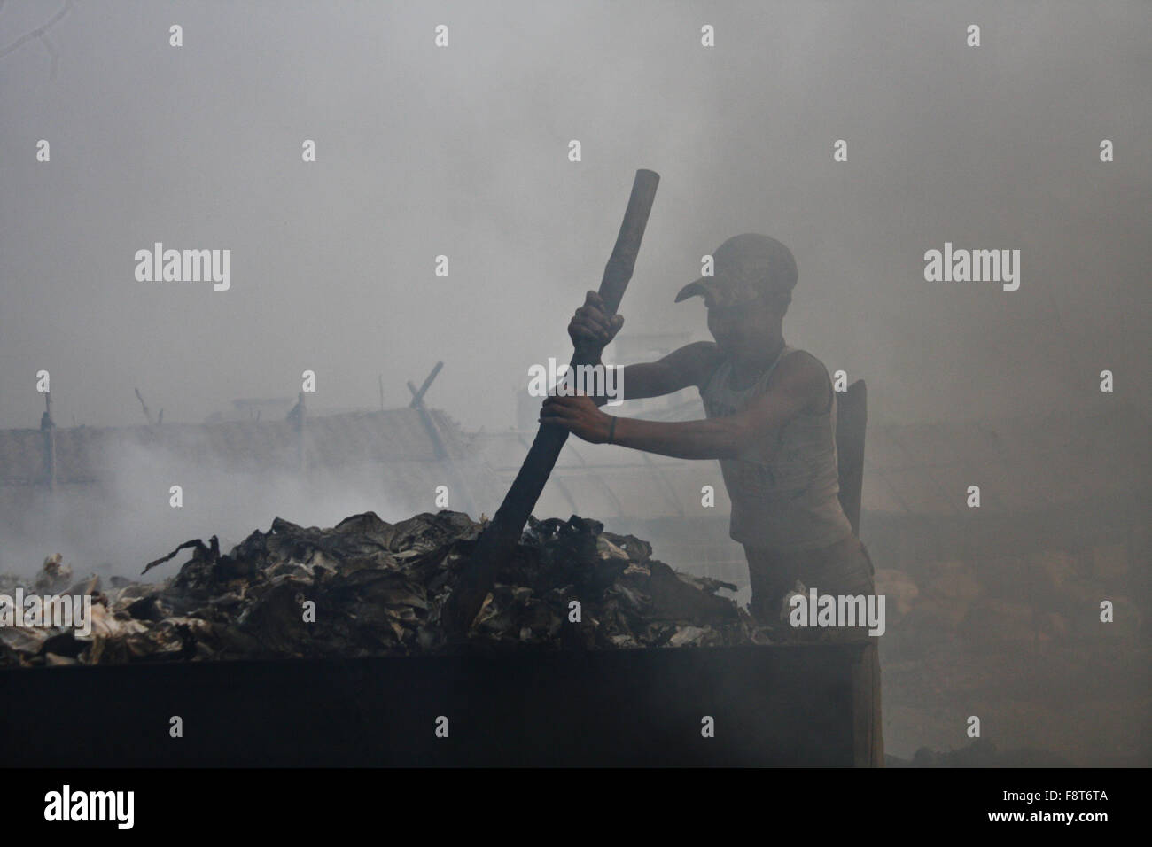 A Bangladeshi day labor works in the polluted environment at Hazaribagh tannery area in Dhaka, Bangladesh. Stock Photo