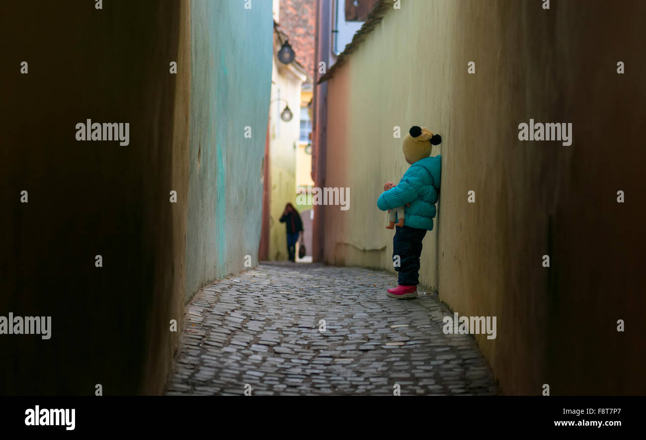 Alone sad child lost on a street Stock Photo