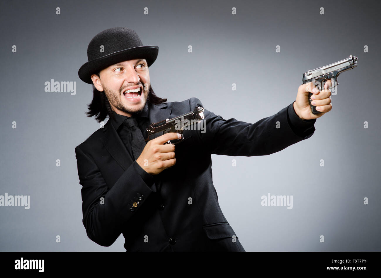 Man wearing vintage hat with gun Stock Photo Alamy