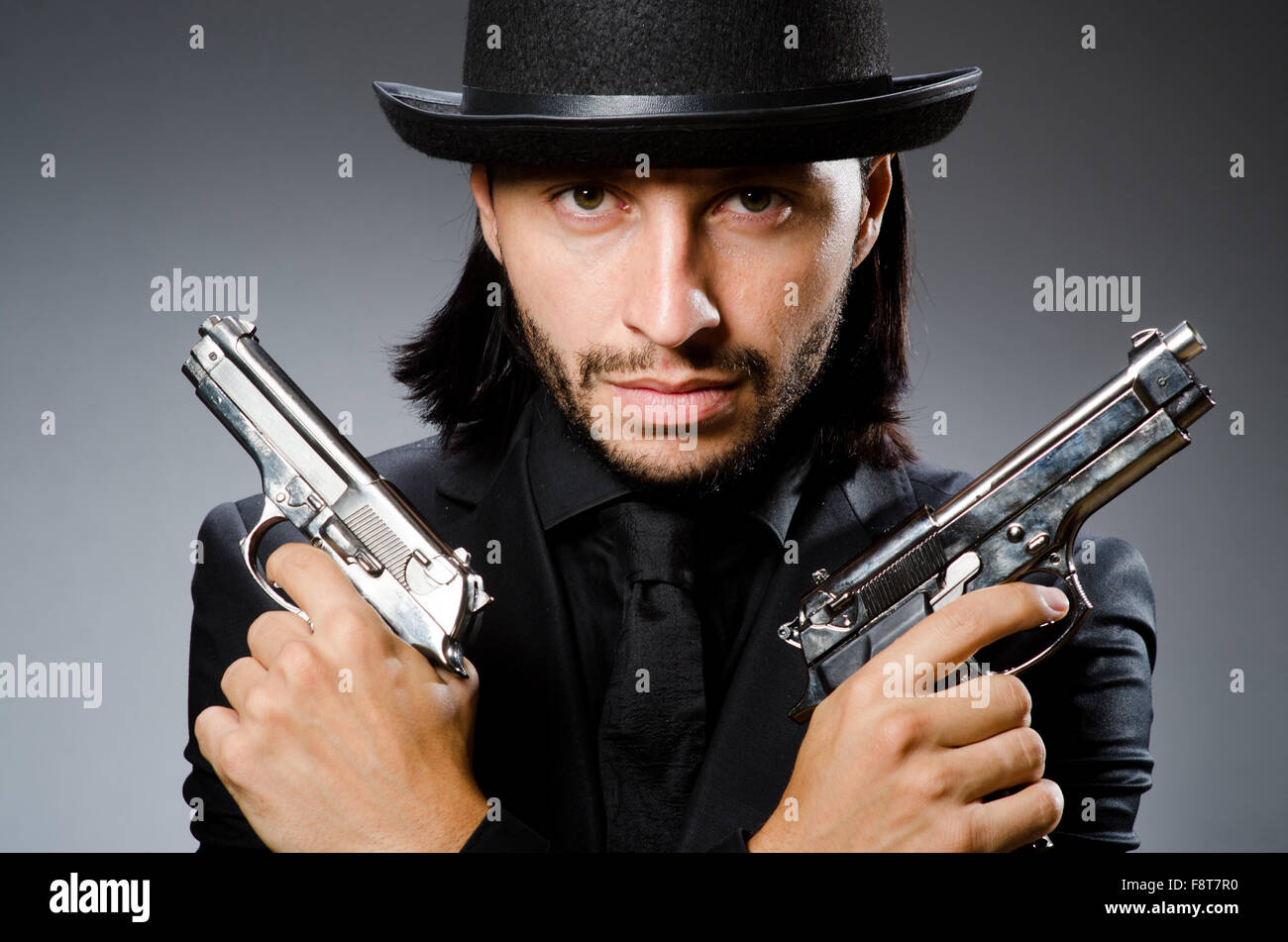 Man wearing vintage hat with gun Stock Photo Alamy