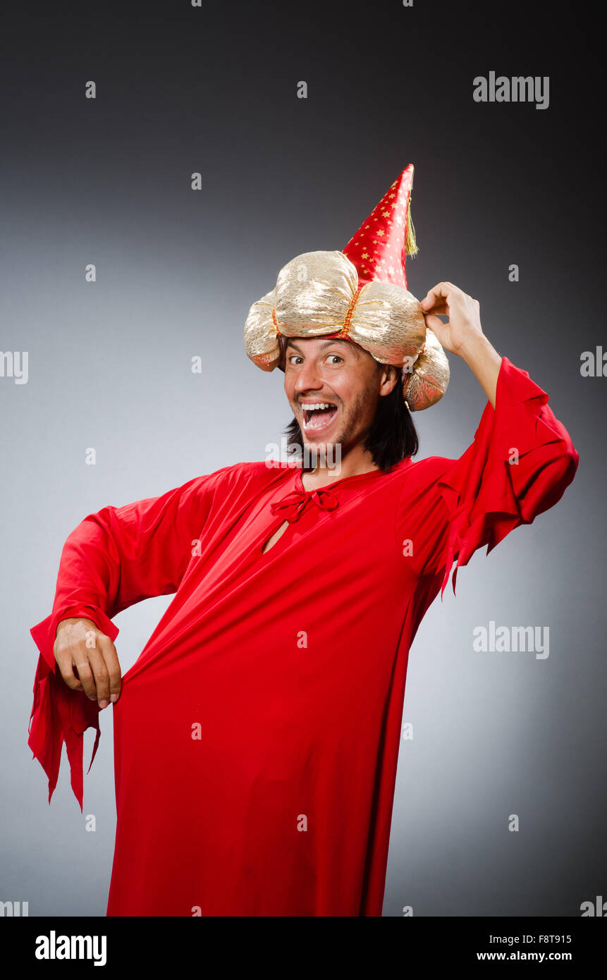 Funny wizard wearing red dress Stock Photo - Alamy