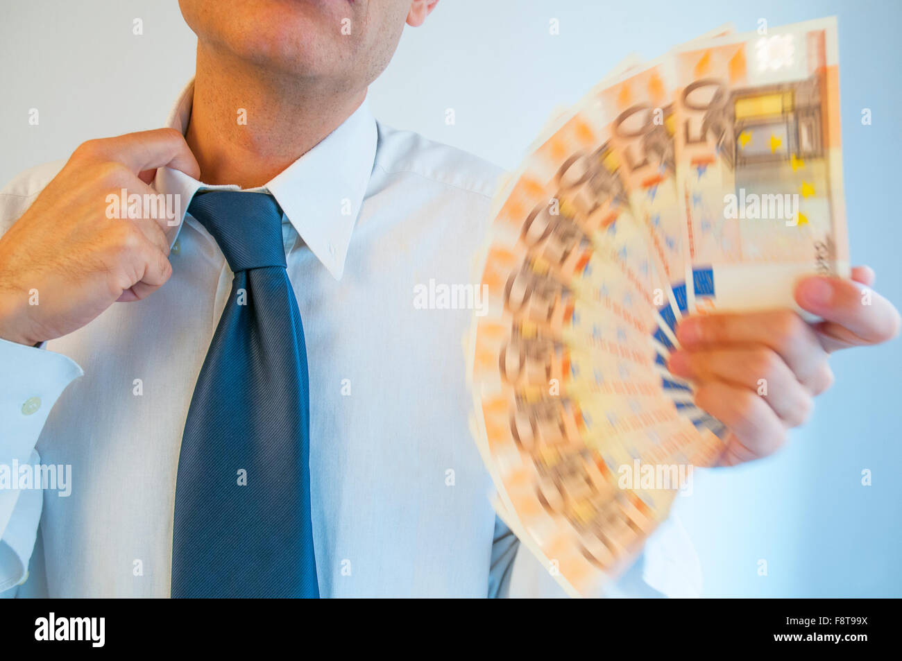 Man fanning himself with bank notes. Close view. Stock Photo
