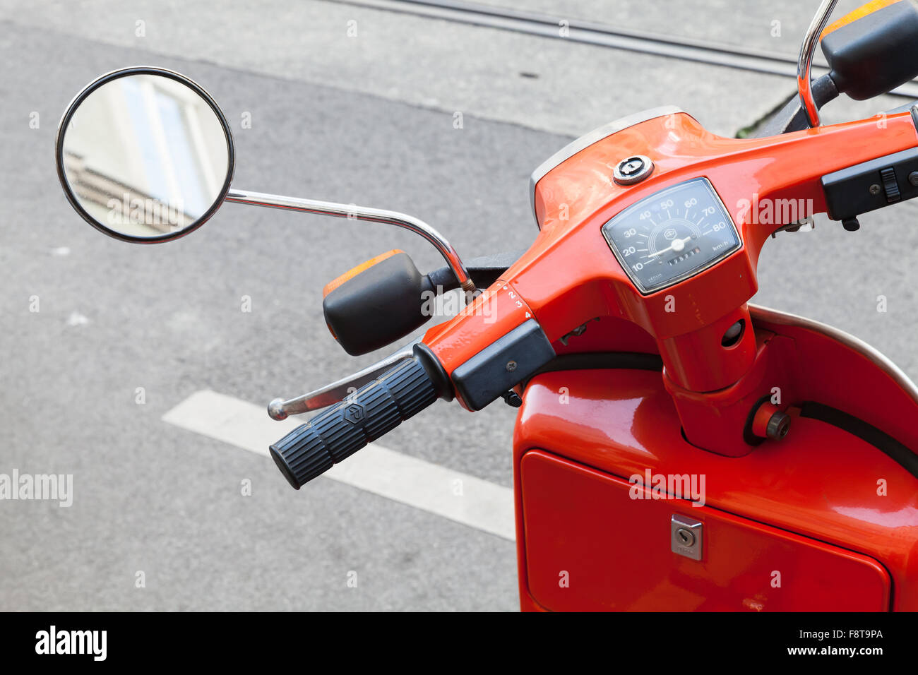Vienna, Austria - November 4, 2015: Red classical Italian Piaggio scooter handlebar with speedometer and mirror Stock Photo