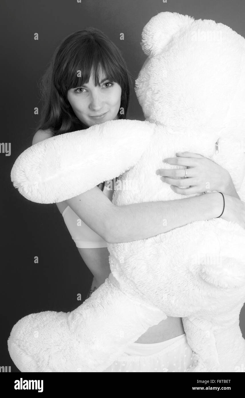 Young woman with a huge teddy bear Stock Photo