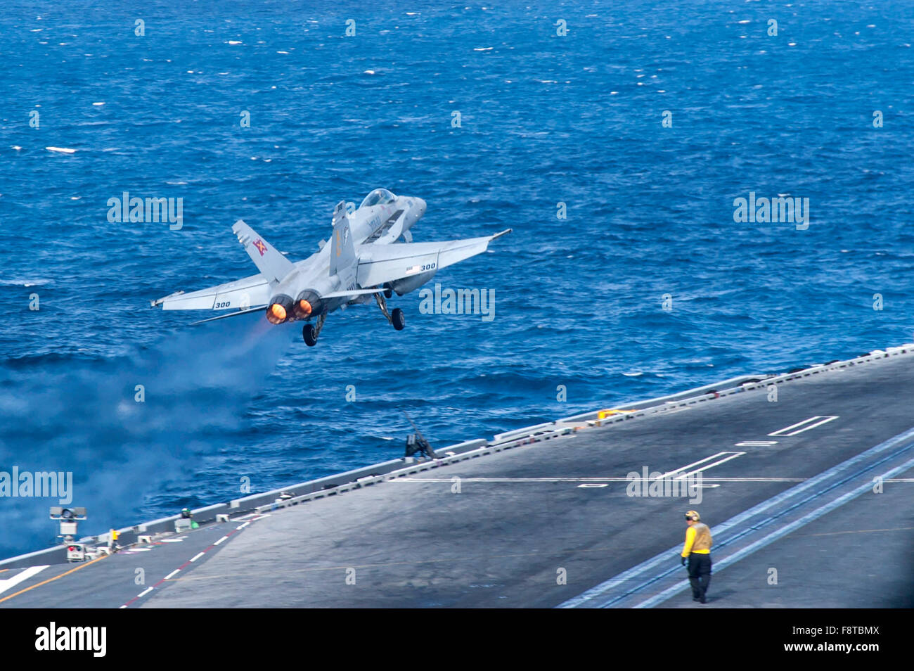 An F/A-18C Hornet assigned to the Rampagers of Strike Fighter Squadron (VFA) 83 launches from the flight deck of the aircraft carrier USS Harry S. Truman Stock Photo