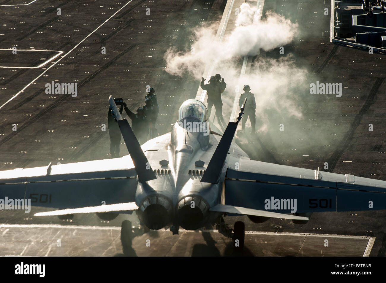 Sailors direct an EA-18G Growler, assigned to the “Patriots” of Electronic Attack Squadron (VAQ) 140, on the flight deck of aircraft carrier USS Harry S. Truman (CVN 75). Stock Photo