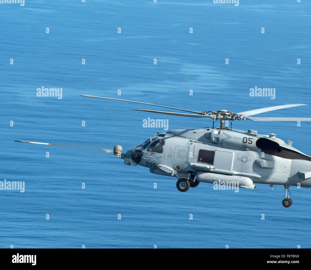MH-60R Sea Hawk helicopter attached to the Raptors of Helicopter Maritime Strike Squadron (HSM) 71 fires rockets Stock Photo