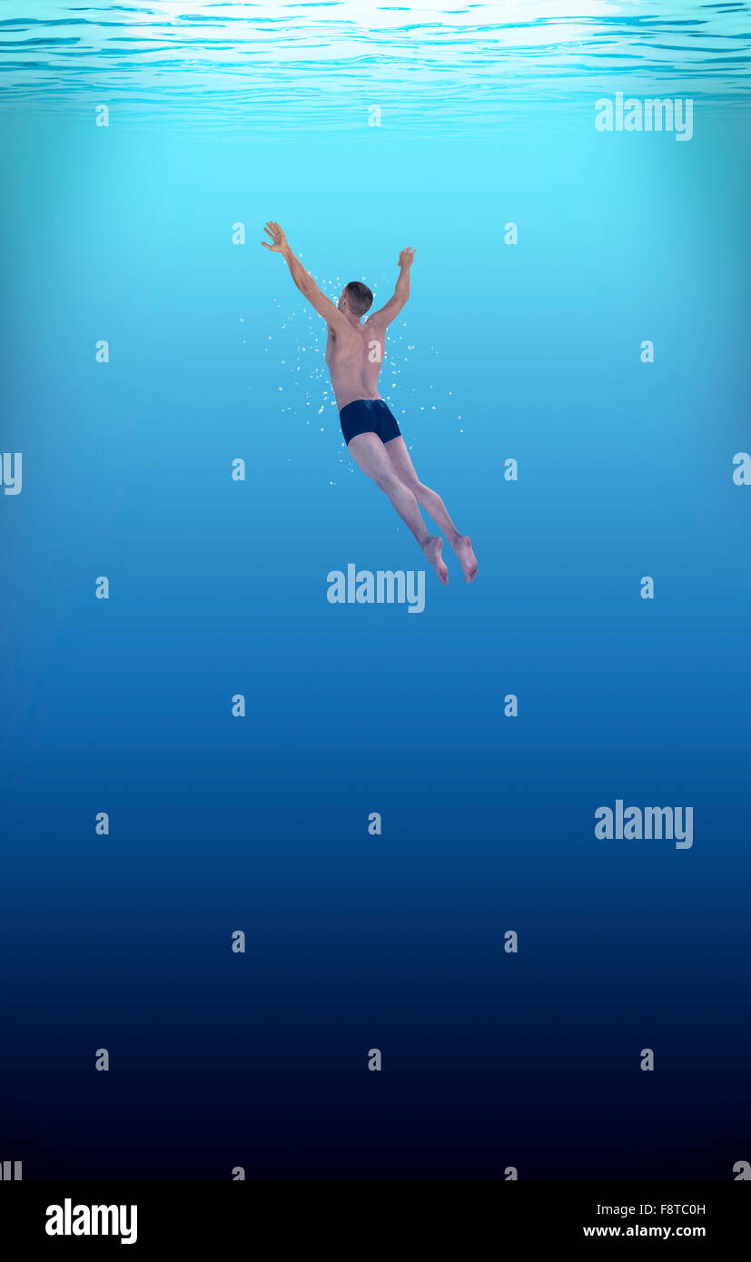 man swimming into deep blue water. Stock Photo