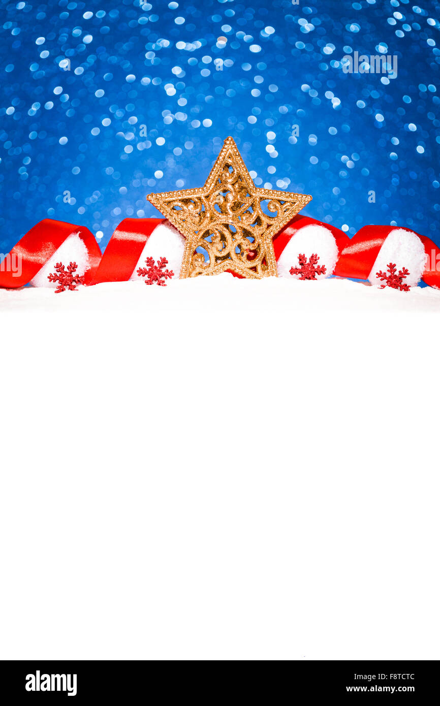 christmas star in snow on glitter blue background Stock Photo - Alamy