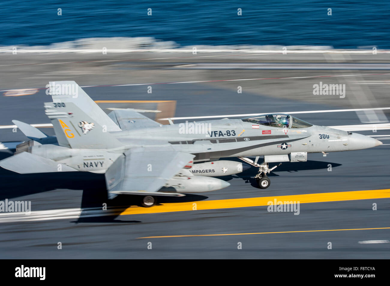 F/A-18C Hornet, assigned to the “Rampagers” of Strike Fighter Squadron (VFA) 83, lands on the flight deck of aircraft carrier USS Harry S. Truman Stock Photo