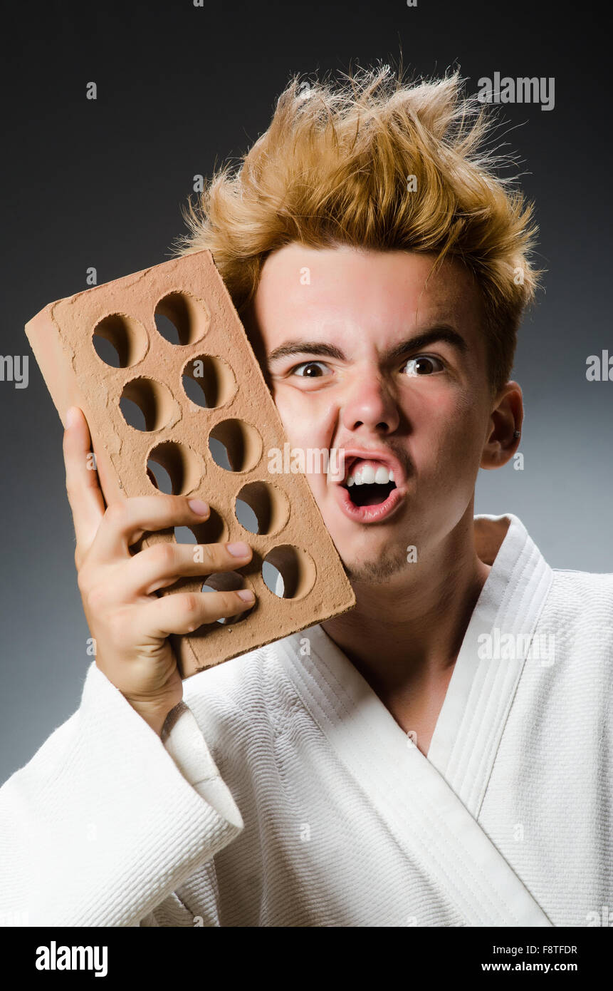 Funny karate fighter with clay brick Stock Photo - Alamy
