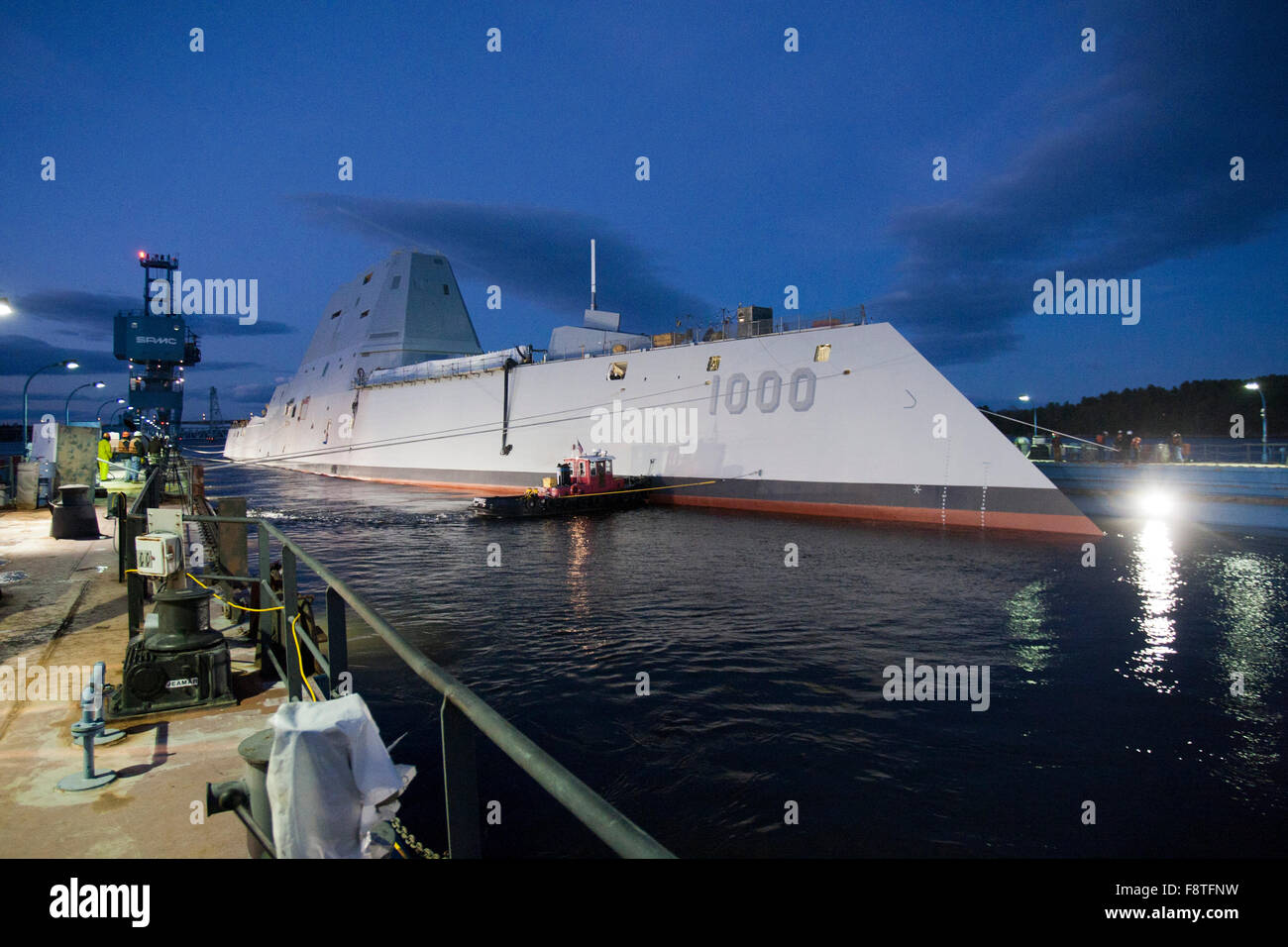 The Zumwalt-class guided-missile destroyer USS Zumwalt is floated out of dry dock at the General Dynamics Bath Iron Works shipyard October 28, 2013 in Bath, Maine. The ship, the first of three Zumwalt-class destroyers is the latest generation of naval technology. Stock Photo