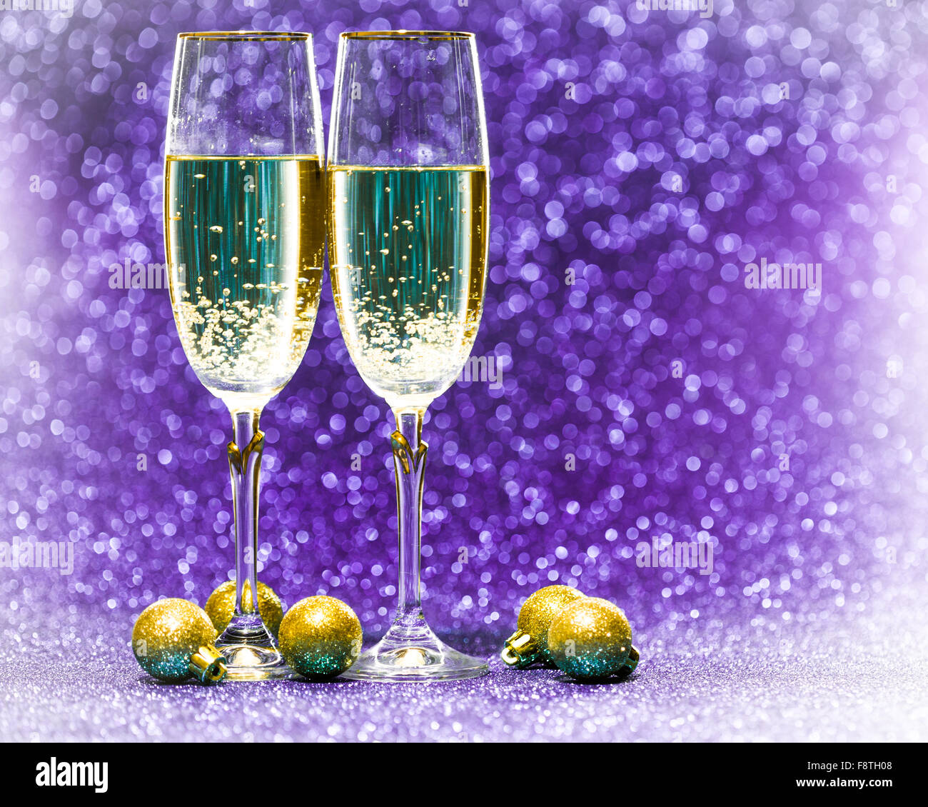 Two glasses of champagne with lights in the background Stock Photo