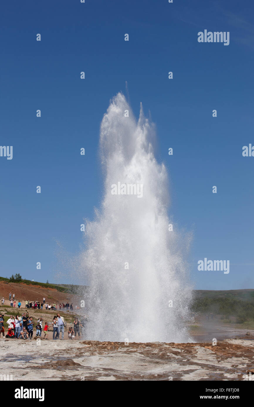 Geyser Strokkur against blue summer sky, erupting hot water and steam ...