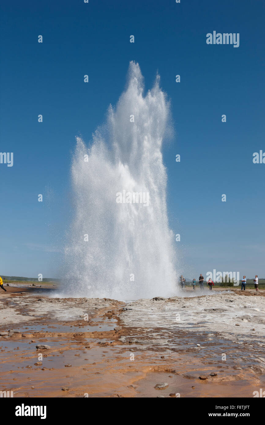 Geyser Strokkur against blue summer sky, erupting hot water and steam ...