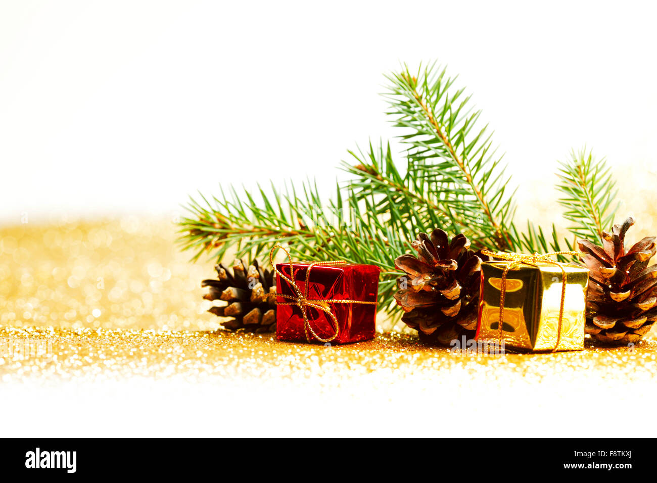 Christmas card with fir branch and decorations on golden gitter ...