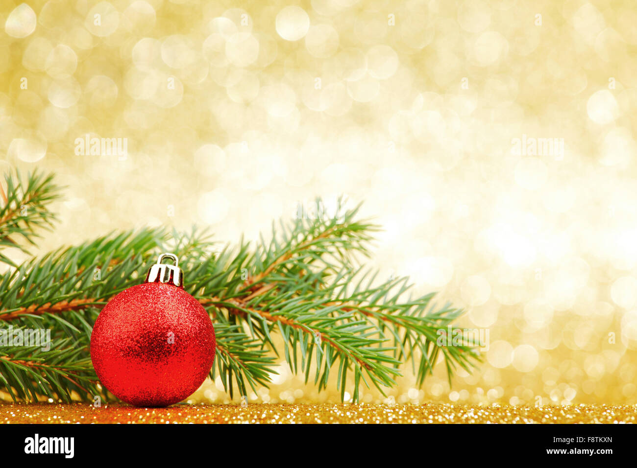 Christmas card with fir branch and decorations on golden gitter ...