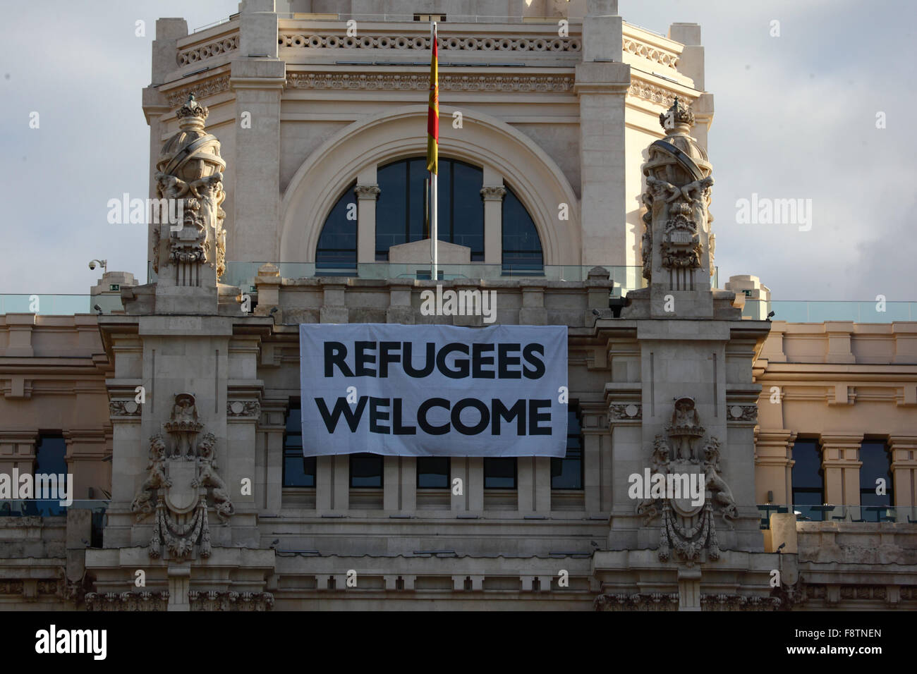 Madrid, Spain 11th December 2015: A 'Refugees Welcome' banner hangs above the entrance of the Palacio de Comunicaciones building. Credit:  James Brunker / Alamy Live News Stock Photo