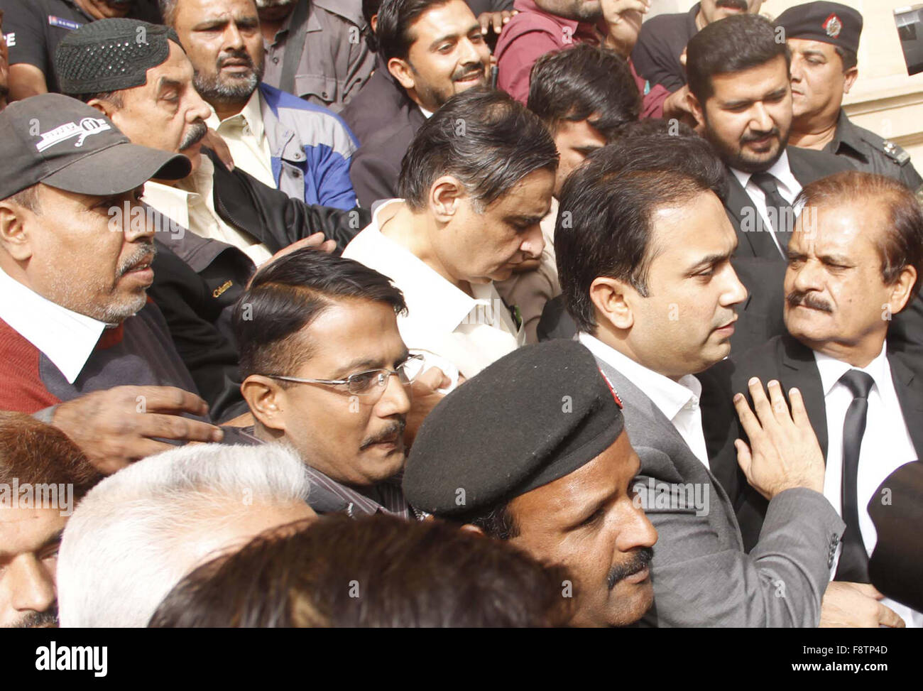 Former federal minister Dr. Asim Hussain being escorting by police towards court on Friday, December 11, 2015. Local accountability court Friday handed over former federal minister Dr. Asim Hussain to National Accountability Bureau (NAB) on seven-day physical remand in a case relating to his alleged role in providing treatment and shelter to terrorists in his hospital. Stock Photo