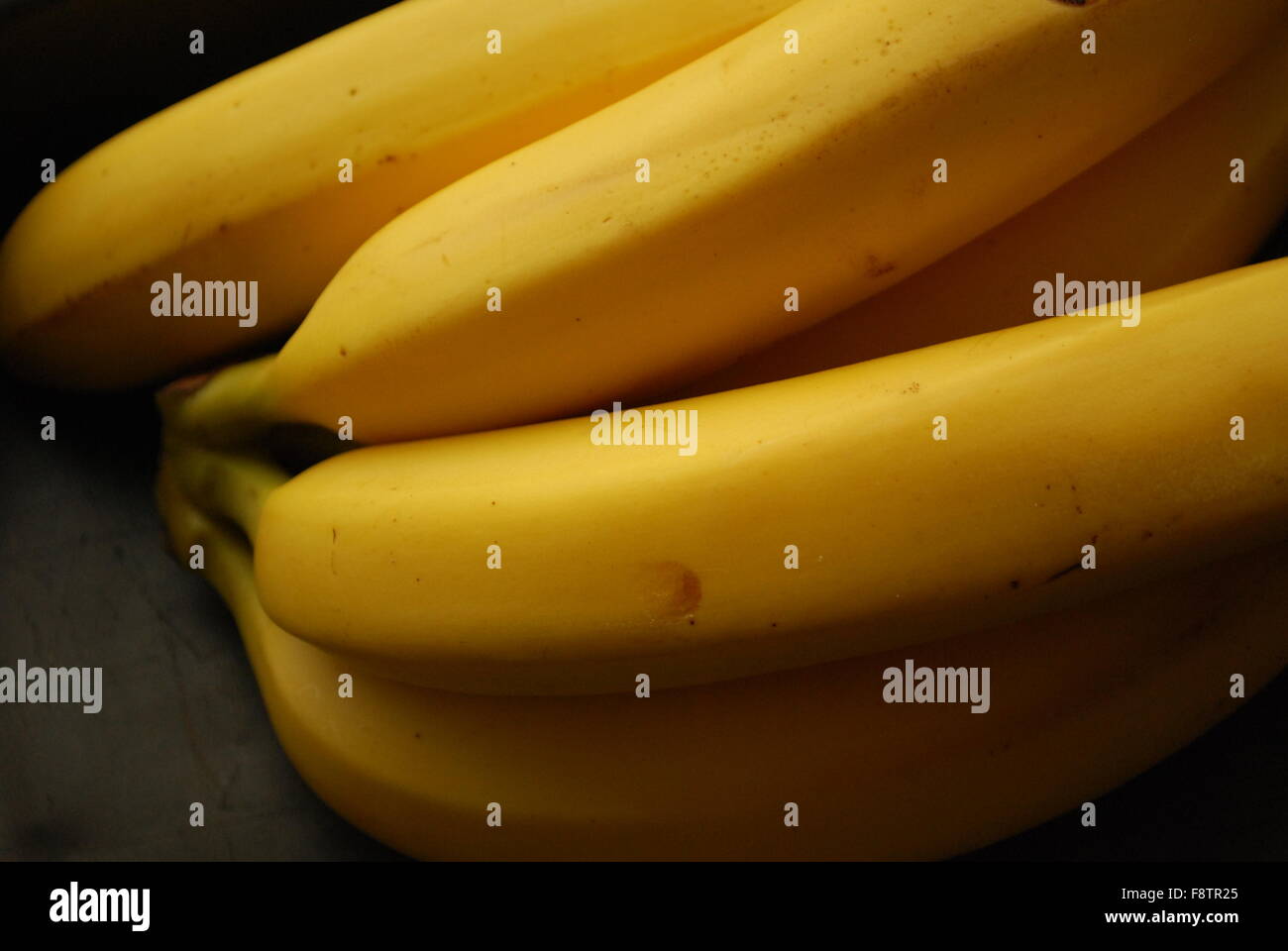 Bananas On Black Stock Photo - Alamy