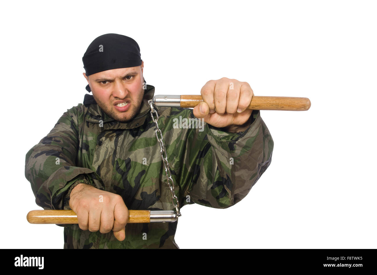 Young man in soldier uniform holding nunchaks isolated on white Stock Photo