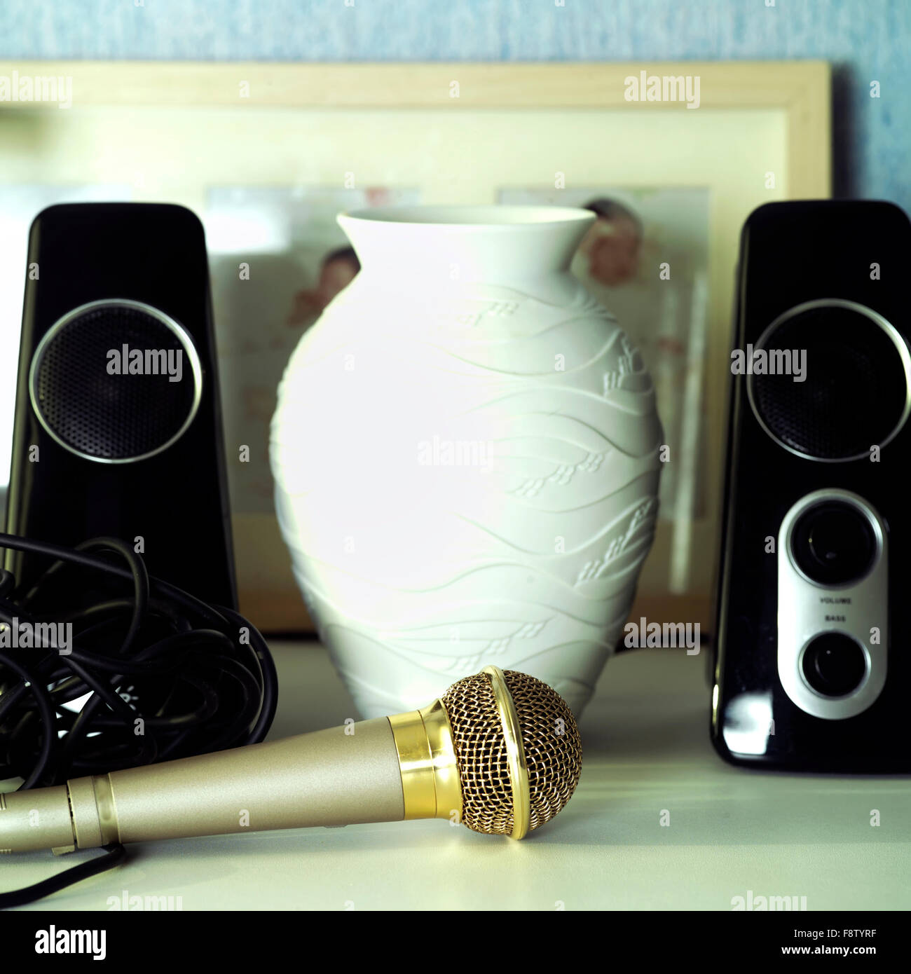 Microphone in focus, loudspeakers in the blurred background. Indoor square shot Stock Photo Alamy