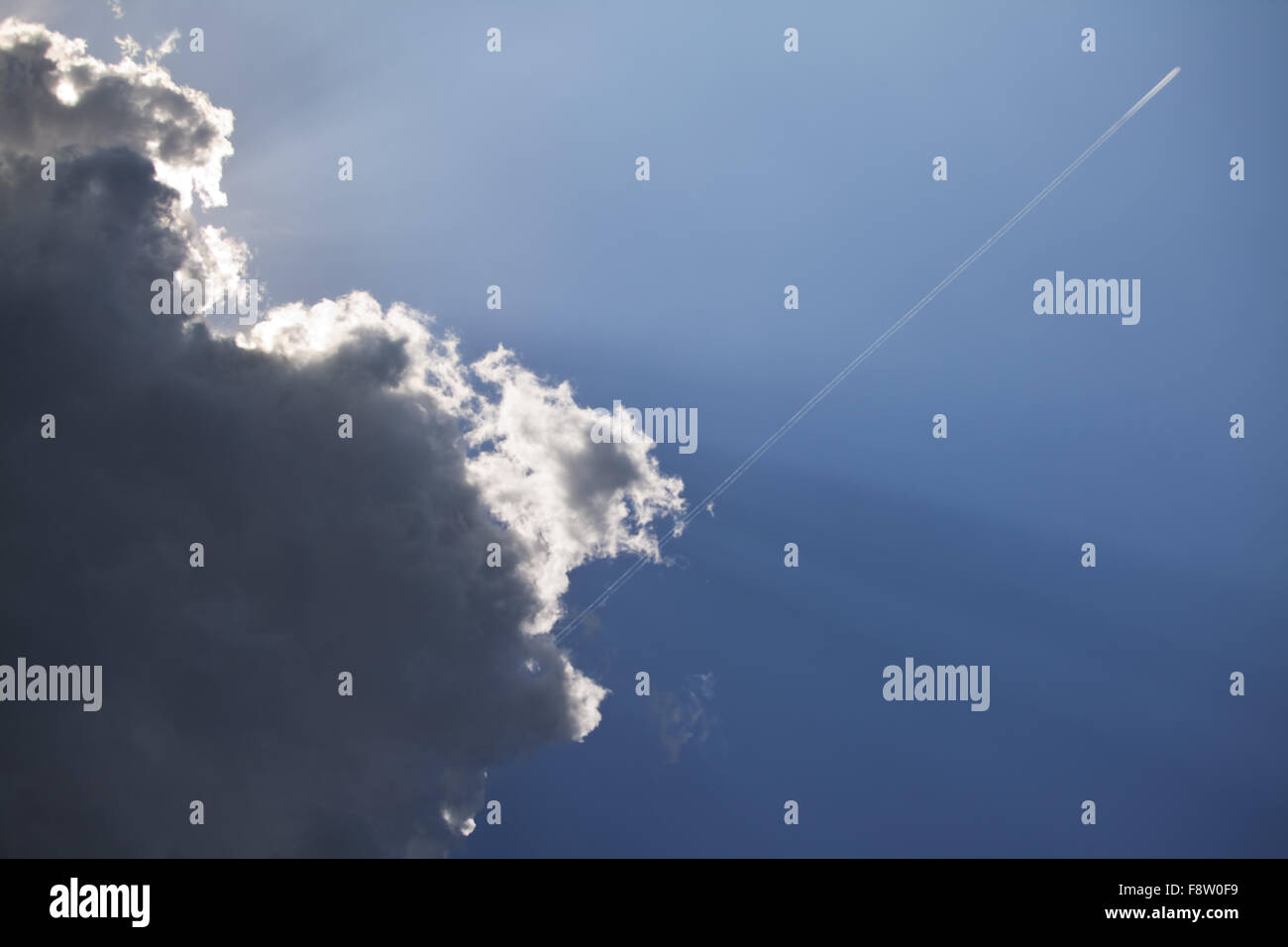 jetplane escaping a dark cloud Stock Photo