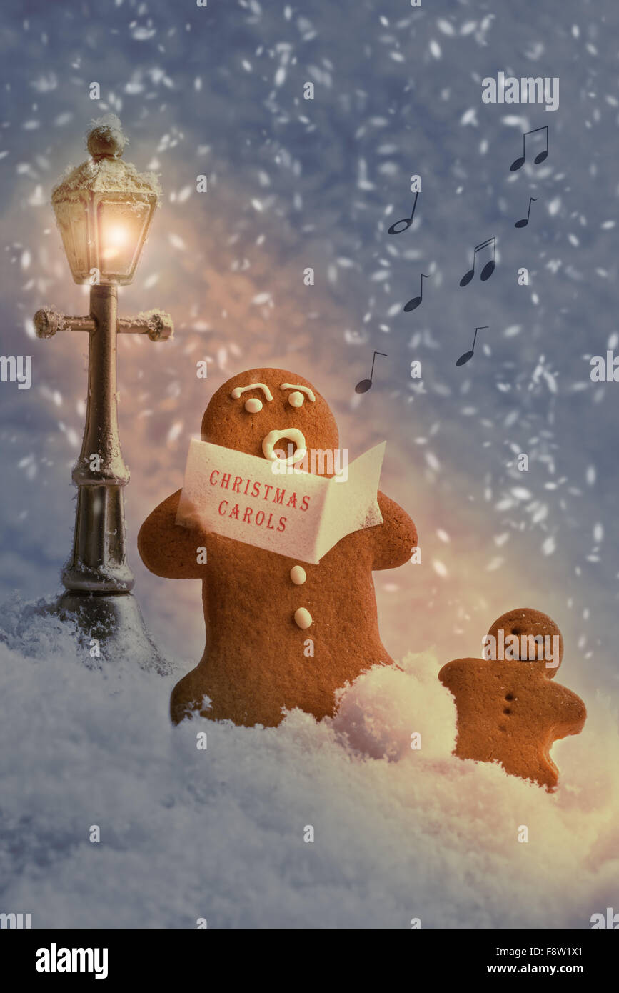 Gingerbread men carol singers at Christmas Stock Photo