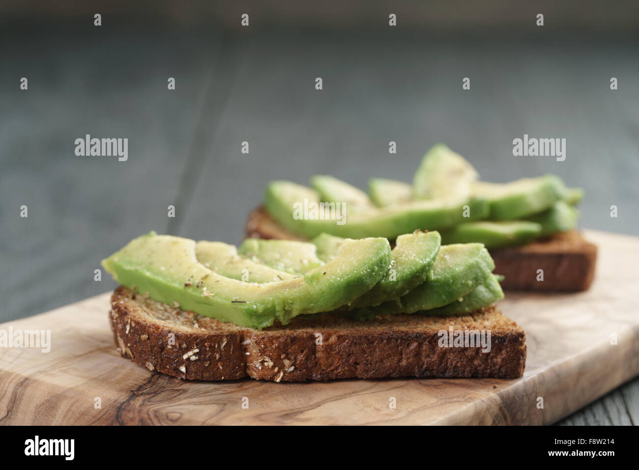 toasted rye bread with sliced avocado and herbs Stock Photo Alamy