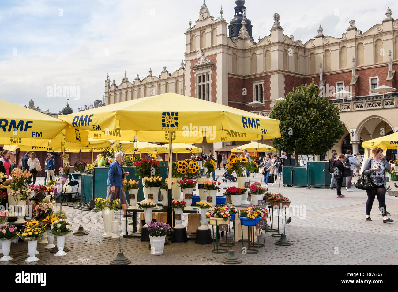Flower stalls selling flowers outside Sukiennice (Cloth Hall or Drapers' Hall) in Market Square (Rynek Glowny) Krakow Poland Stock Photo