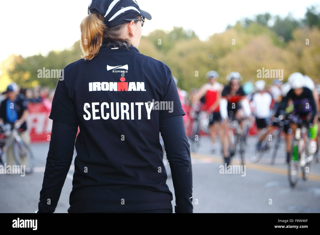 Female volunteer working security at the Louisville Ironman Triathlon. Stock Photo