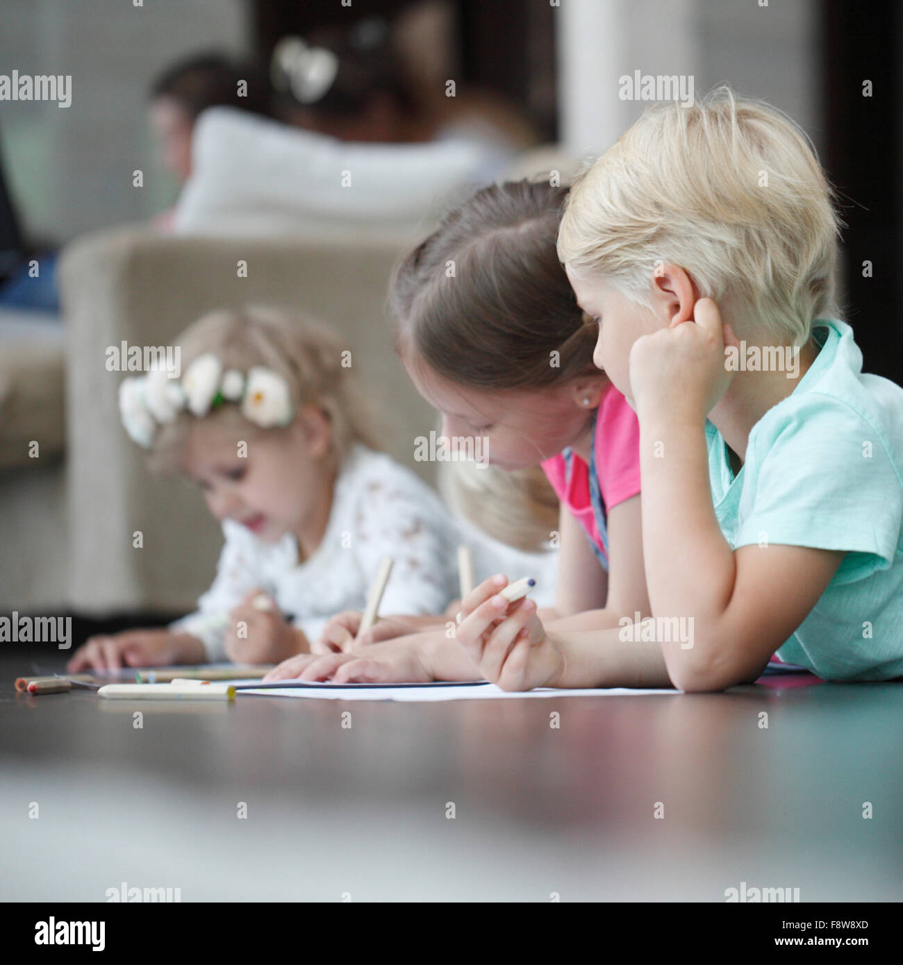 Group of cute children drawing with colorful pencils on floor Stock ...