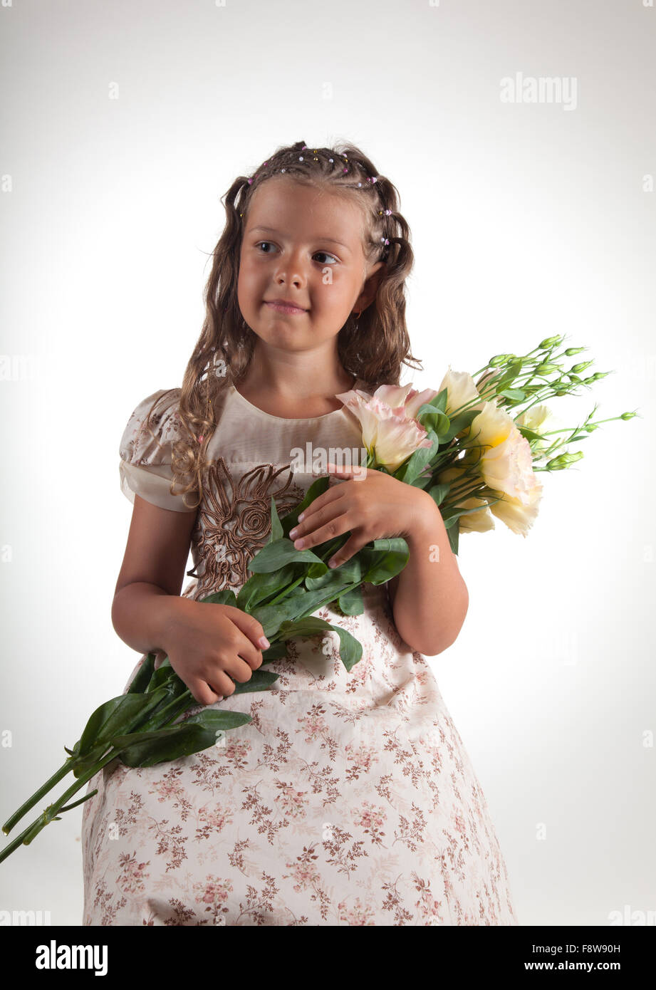 Cute little girl holding flowers Stock Photo