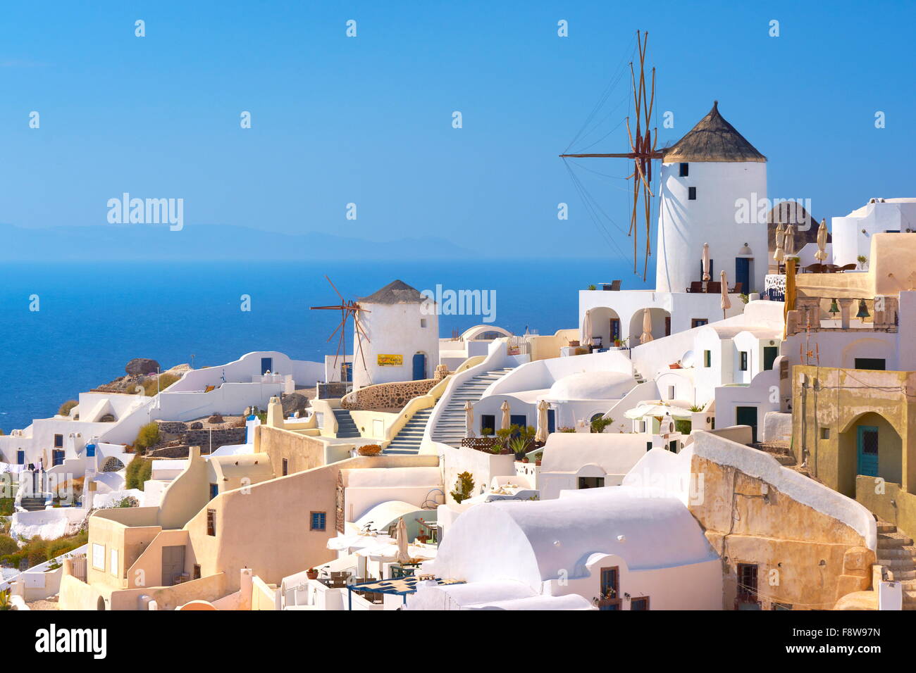 Santorini Island - white houses and windmills on the blue sky, Oia, Greece Stock Photo