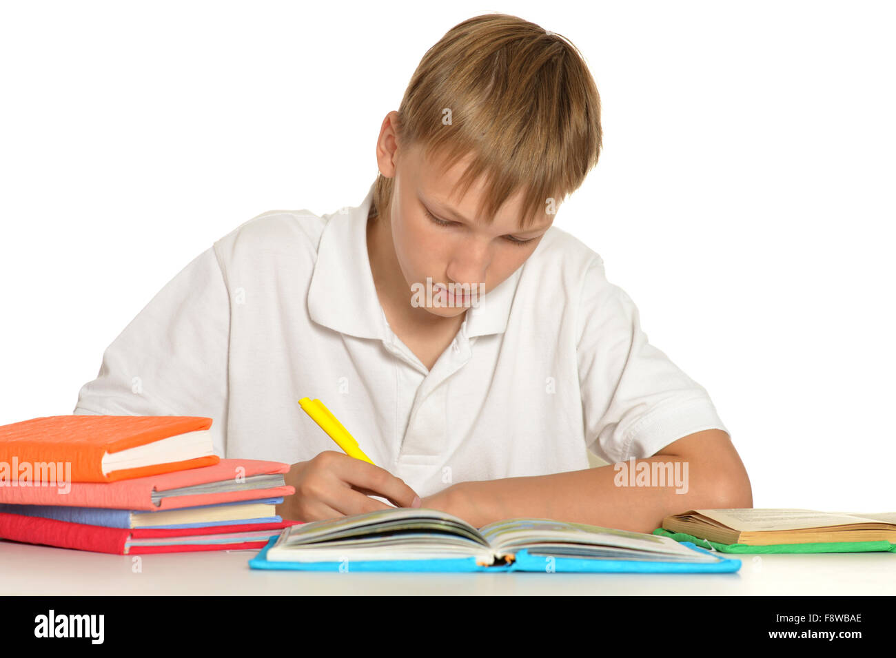 Teenage boy doing homework Stock Photo - Alamy