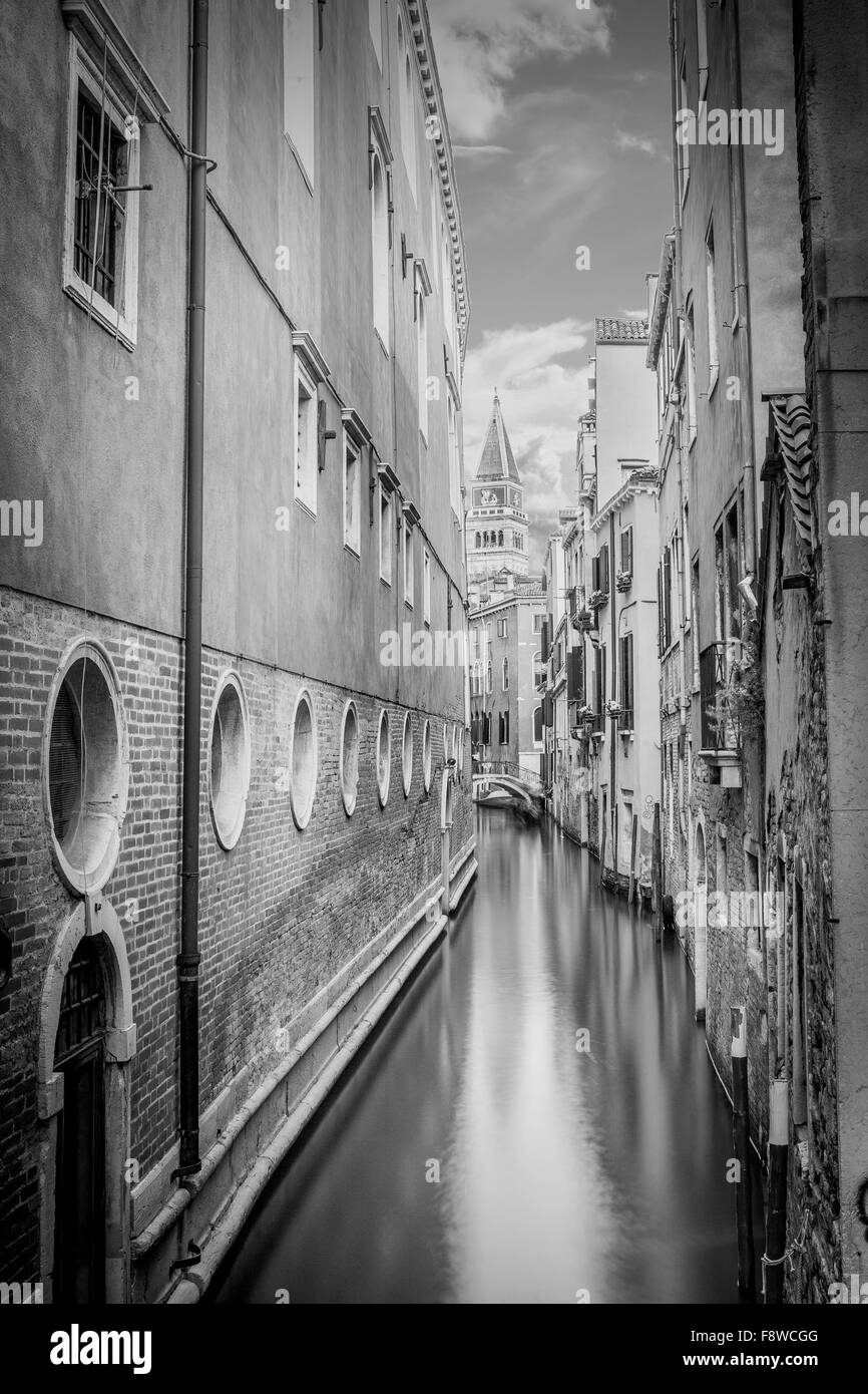 B&W narrow canal with silky water in Venice, Italy Stock Photo - Alamy