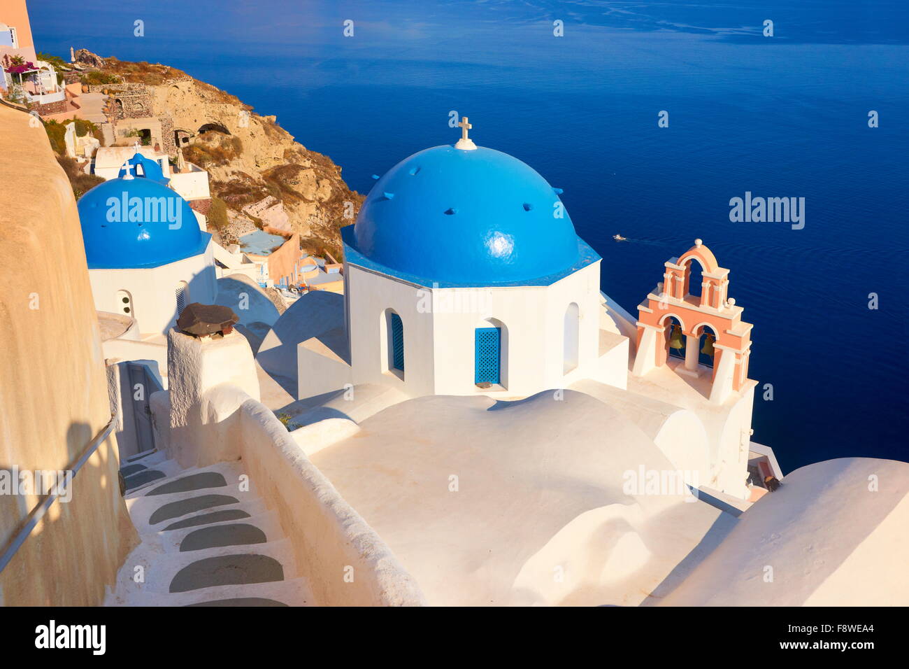 Popular Santorini Caldera landscape with greek white church overlooking the sea, Oia Town, Santorini Island, Greece Stock Photo