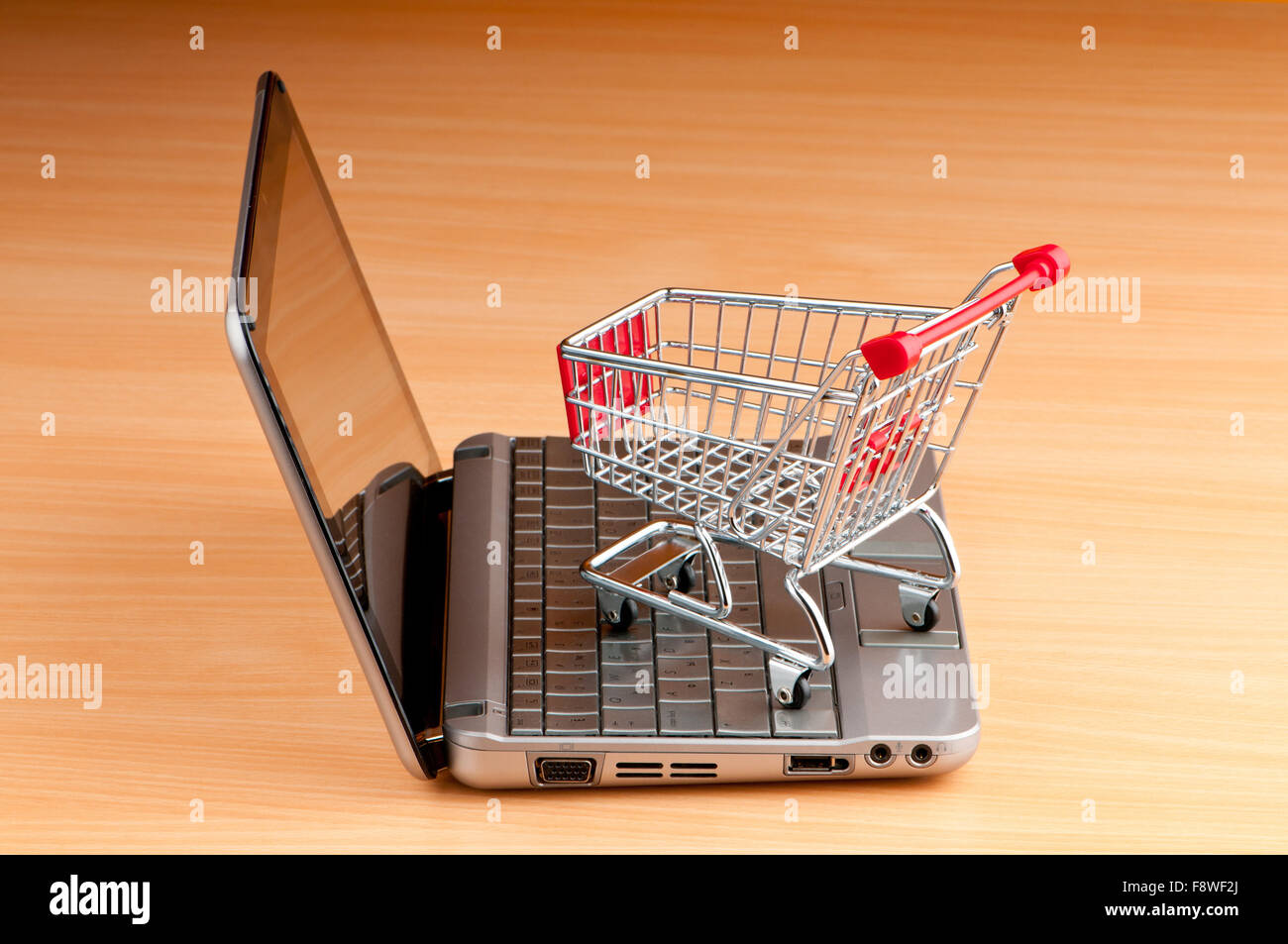 Internet online shopping concept with computer and cart Stock Photo - Alamy