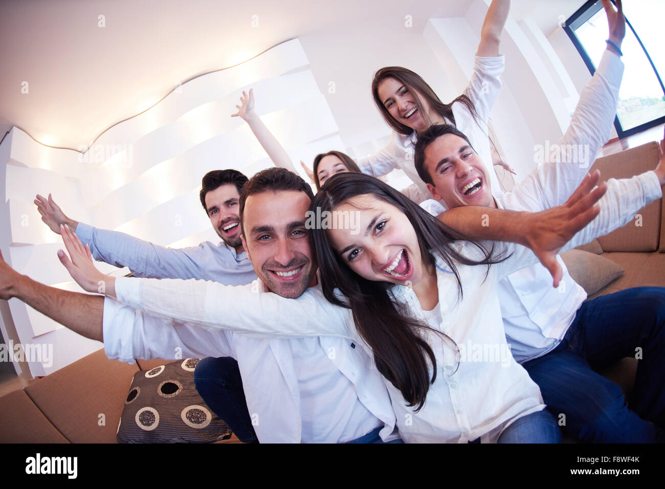 group of friends taking selfie photo with tablet at modern home indoors ...