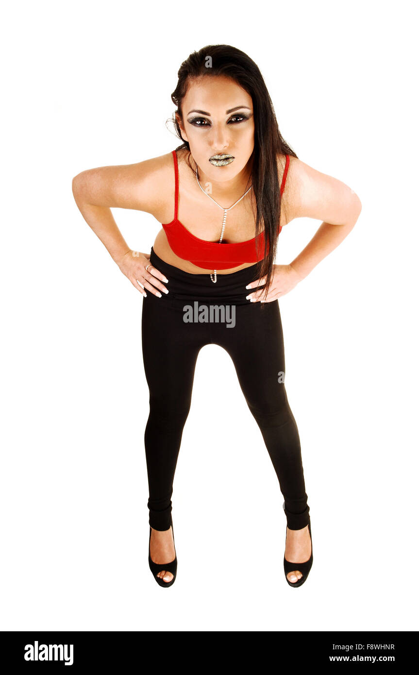 A young teen girl in black tights and a red top, with long black hair  standing for white background, bending forwards, with Stock Photo - Alamy