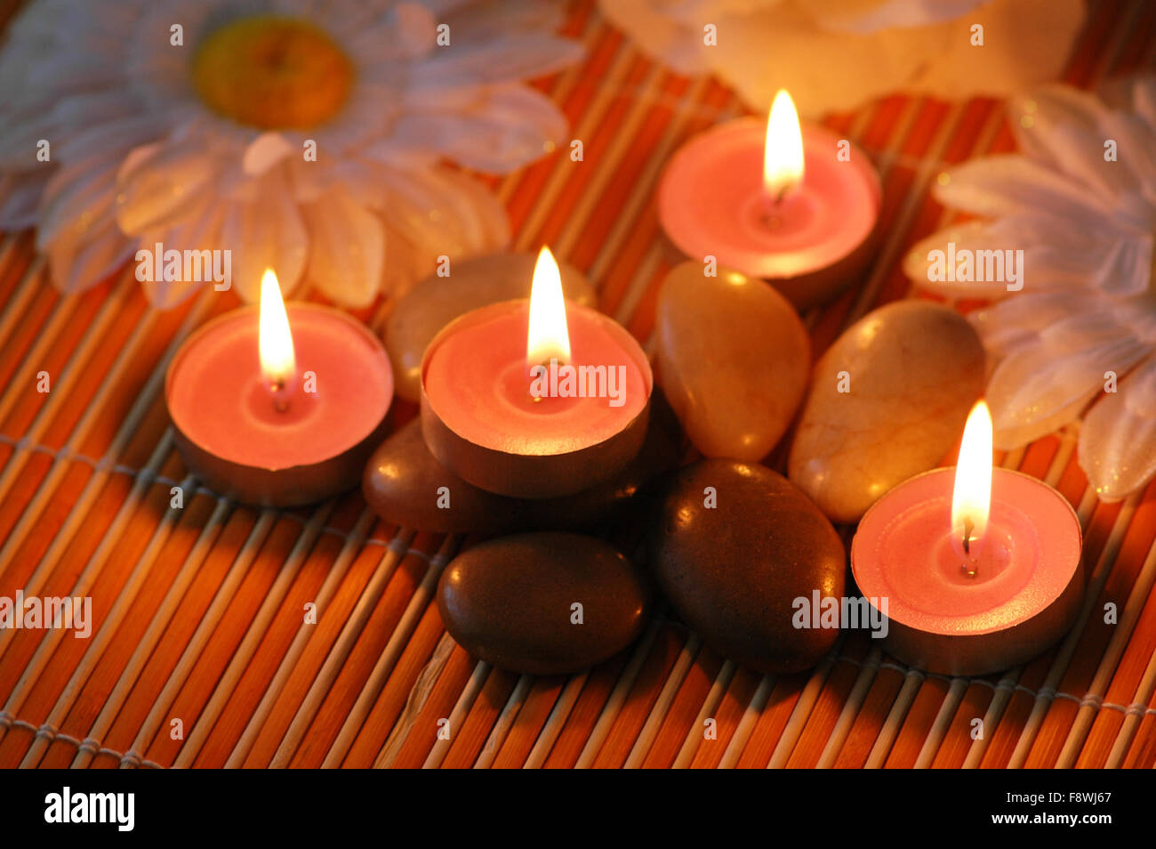 Aromatic candles and pebbles for spa session Stock Photo Alamy