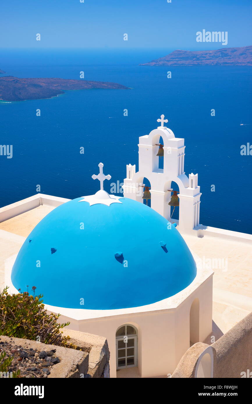 Thira Fira (capital of Santorini) - View at greek church with blue dome, bell tower and  blue sea, Santorini Island, Greece Stock Photo