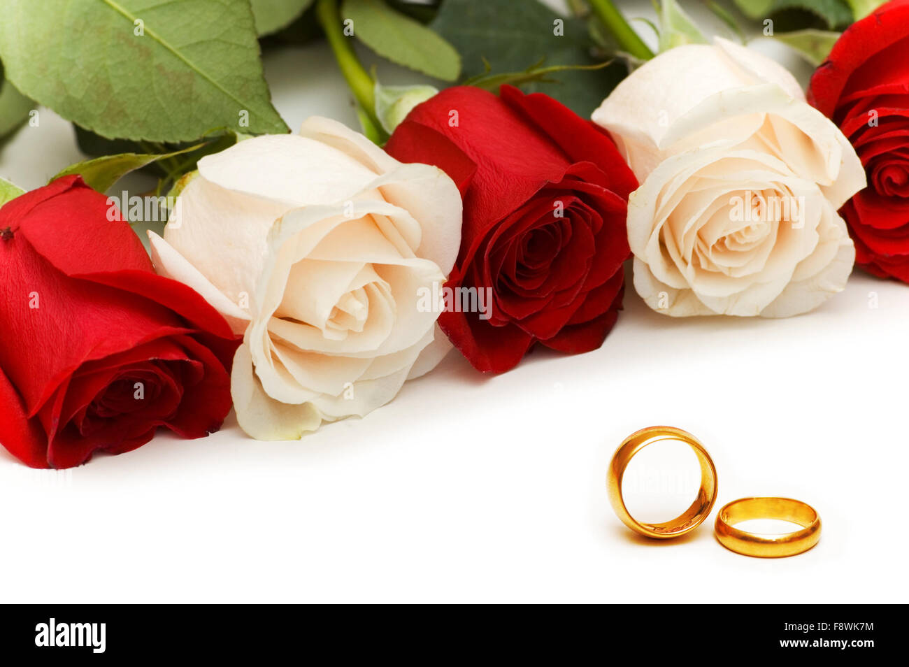 Roses and wedding rings isolated on the white Stock Photo - Alamy