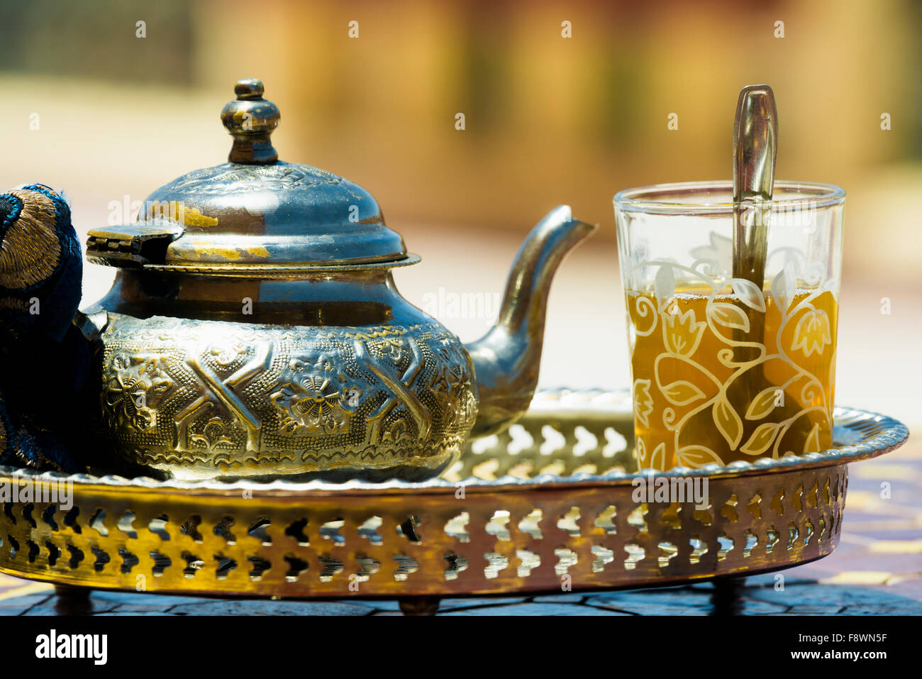 Glass with mint tea and silver teapot, Morocco Stock Photo
