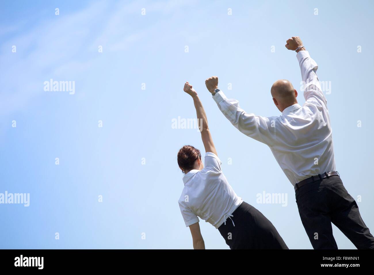 Woman arms raised rear view hi-res stock photography and images - Alamy