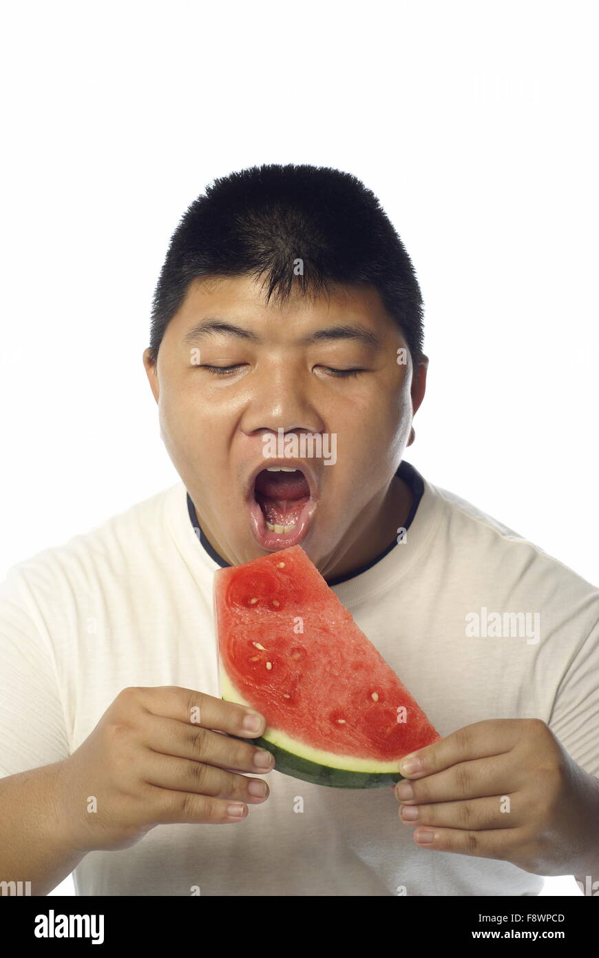 Asian man about to eat water melon Stock Photo Alamy