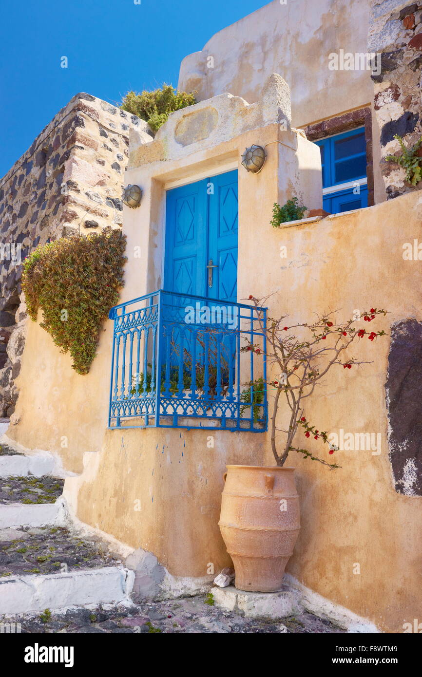 Street scene with a greek vase and blue door in Pyrgos, Santorini Island, Cyclades Islands, Greece Stock Photo
