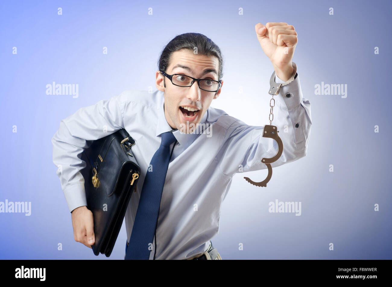 Businessman with handcuffs running away Stock Photo Alamy