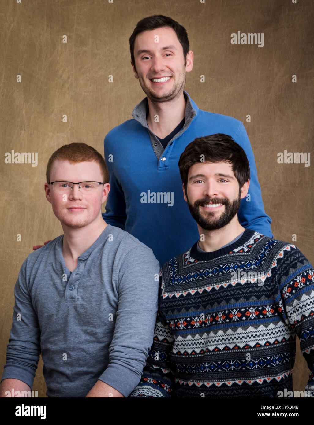 Studio portrait of three grown male cousins Stock Photo